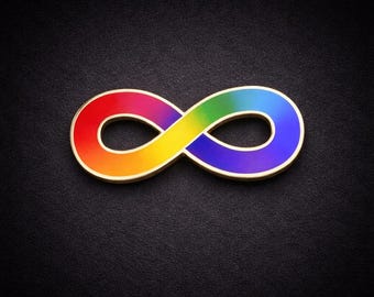 May include: A gold-colored infinity symbol pin with a rainbow gradient of colors, including red, orange, yellow, green, and blue. The pin is set against a black background.