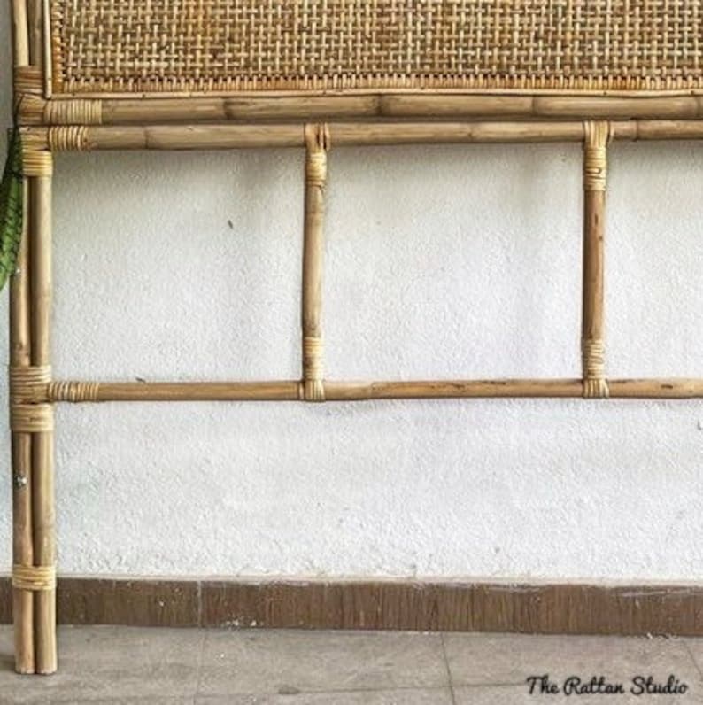 May include: A natural woven headboard with a bamboo frame. The headboard has a woven rattan panel and a simple design.