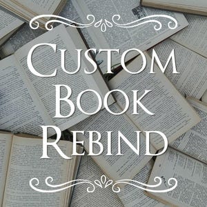 May include: A collection of open books with visible text on the pages, arranged in an overlapping pattern. The white text "CUSTOM BOOK REBIND" is centered on the image, framed by decorative white flourishes at the top and bottom of the lettering.