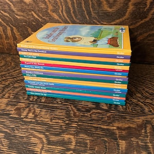 May include: A stack of 14 children's books with colourful covers. The books are all part of the "Bradley and the Great Swamp Mystery" series. The titles of the books are visible on the spines. The books are published by Grolier.