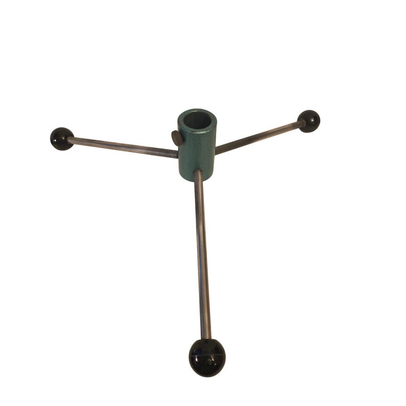 May include: A metal Christmas tree stand with a teal-colored central tube and three silver legs. Each leg has a black ball at the end. The stand is designed to hold a Christmas tree upright.