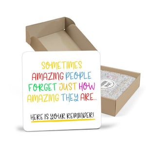 May include: A white card with the text "SOMETIMES AMAZING PEOPLE FORGET JUST HOW AMAZING THEY ARE... HERE IS YOUR REMINDER!" in colorful letters.