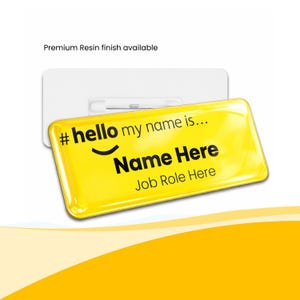 May include: A yellow name badge with the text "# hello my name is..." and placeholders for "Name Here" and "Job Role Here". The badge has a glossy finish and a white backing with a pin. The text "Premium Resin finish available" is above the badge.