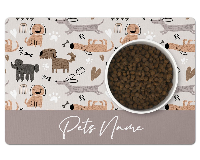 May include: A white dog bowl with brown dog food inside, sitting on a gray and white dog-themed placemat with the text "Pets Name".