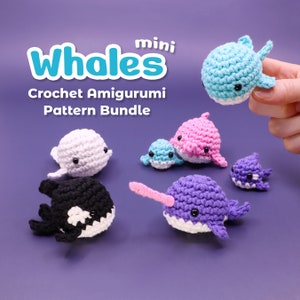 May include: A set of mini crochet whale amigurumi patterns. The patterns include a blue whale, a pink whale, a white beluga whale, a purple narwhal, and a black and white orca whale.
