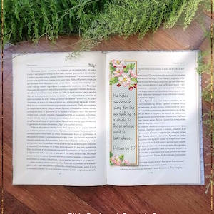 May include: A counted cross stitch pattern for a bookmark featuring a floral design and the Bible verse Proverbs 2:7, "He holds success in store for the upright, he is a shield to those whose walk is blameless."