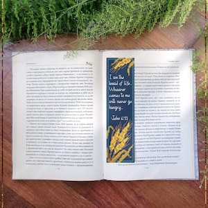 May include: A blue and gold counted cross stitch bookmark with the text "I am the bread of life. Whoever comes to me will never go hungry - John 6:35". The bookmark features a design of wheat stalks.