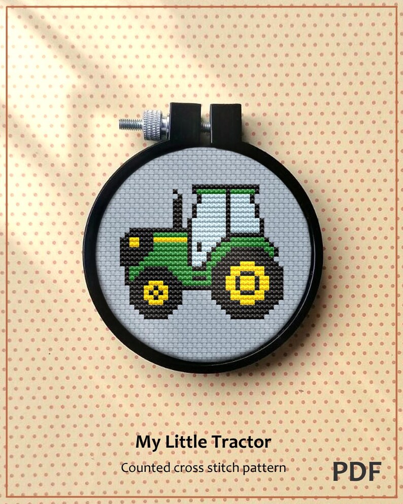 Pu&ograve; includere: Uno schema di punto croce contato per un trattore verde e giallo. Lo schema &egrave; in un telaio da ricamo nero e il testo "My Little Tractor" e "Counted cross stitch pattern" &egrave; sotto il telaio. Il testo "PDF" &egrave; nell'angolo in basso a destra.