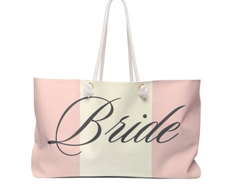 May include: A white tote bag with pink stripes and the word "Bride" in black script.