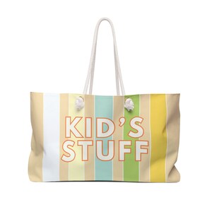 May include: A striped tote bag with white rope handles. The bag has a colorful striped design with the text "KID'S STUFF" in orange.