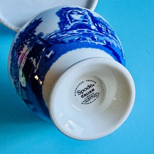 May include: White and blue Spode Italian creamer with a detailed landscape design. The creamer features a classic shape and is dishwasher and microwave safe. The bottom of the creamer has the Spode Italian logo.