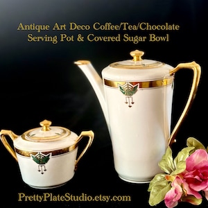 May include: Antique Art Deco coffee, tea, or chocolate serving pot and covered sugar bowl. Both pieces are white porcelain with gold trim and green and gold geometric designs. The text "PrettyPlateStudio.etsy.com" is visible at the bottom of the image.