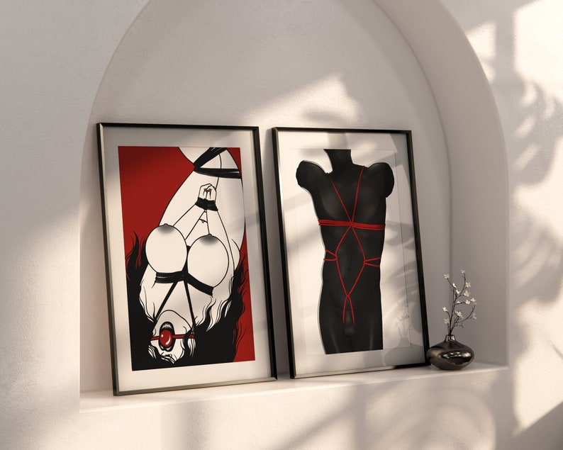 May include: Two framed black and white illustrations. The left illustration shows a person tied up with red rope and a red ball gag. The right illustration shows a torso tied up with red rope.