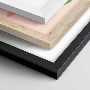 May include: Three picture frames stacked on top of each other. The top frame is white, the middle frame is light wood, and the bottom frame is black.