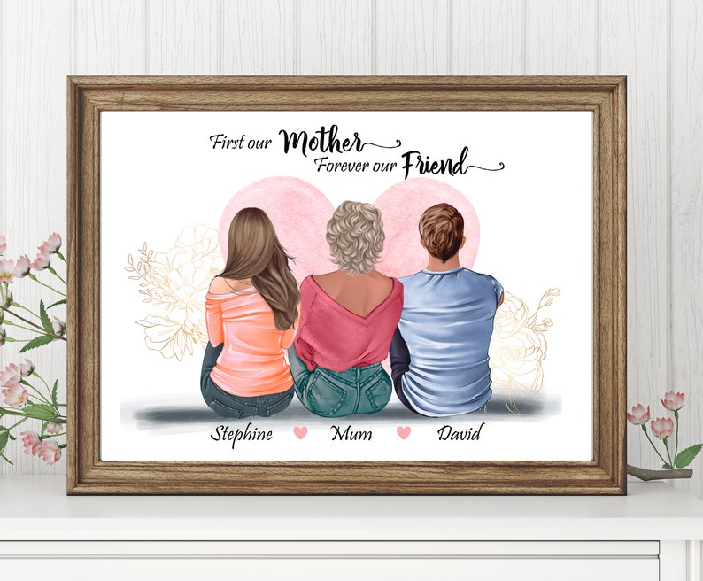 May include: A framed print with a white background and three people sitting with their backs to the viewer. The text "First our Mother Forever our Friend" is at the top of the print. The people are labeled "Stephine", "Mum", and "David".