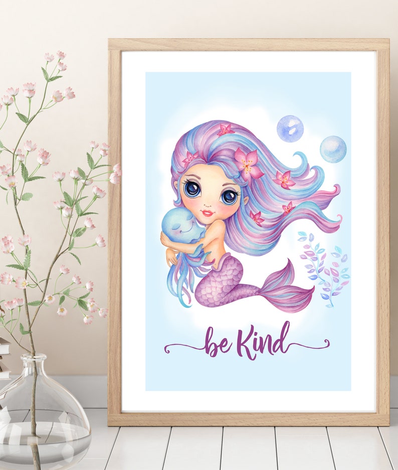 May include: A watercolor illustration of a mermaid with long purple and blue hair holding a small blue octopus. The mermaid has big blue eyes and is wearing a purple tail. The background is light blue with bubbles and the text "be kind" in purple.