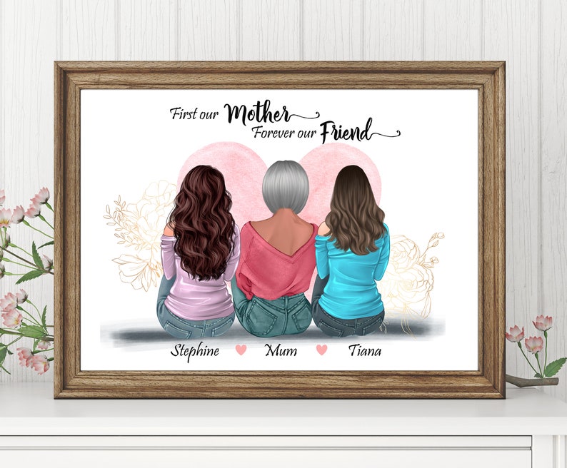 May include: A framed print with a white background featuring three women sitting back to back. The women have brown, gray, and brown hair. The text "First our Mother Forever our Friend" is at the top of the print. The names "Stephine", "Mum", and "Tiana" are written below the women.
