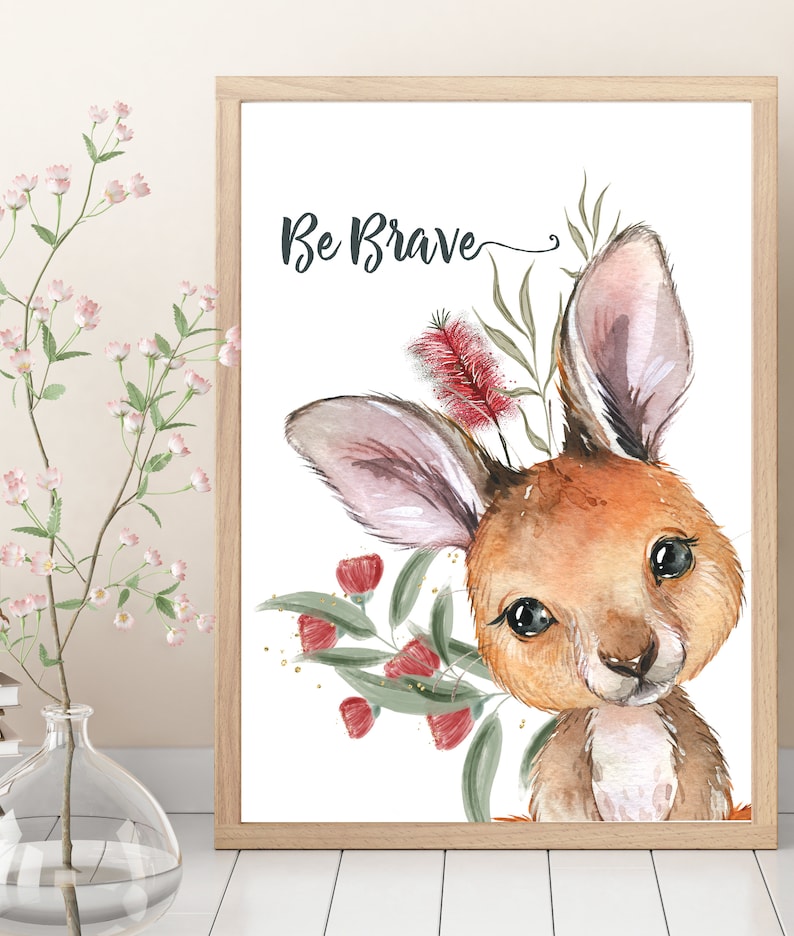 May include: A watercolor illustration of a cute kangaroo with the text "Be Brave" above it. The kangaroo is surrounded by green leaves and red flowers.