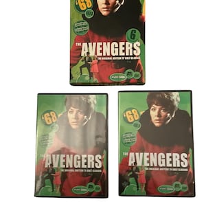 May include: Three DVD sets of "The Avengers," a British TV cult classic. Each DVD case features a woman in a black fur collar and red coat. The cases have the text "68" and "The Avengers" printed on them.
