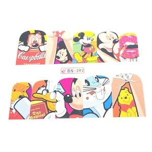 May include: A set of ten nail art decals featuring colorful cartoon characters and pop art imagery, including Mickey Mouse, Donald Duck, Winnie the Pooh, and Bugs Bunny. The sheet is labeled BN-392 and includes various graphic designs.