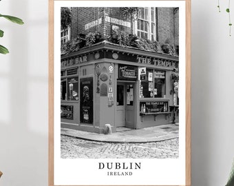 May include: A black and white framed wall art print featuring a street corner view of The Temple Bar in Dublin, Ireland. The print includes the text "THE TEMPLE BAR" on the building facade and the words "DUBLIN IRELAND" printed below the image.