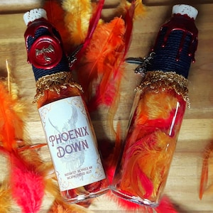 May include: Two glass bottles filled with orange and red feathers, sealed with red wax and a gold label that reads "Phoenix Down" and "Instantly revives an incapacitated ally".