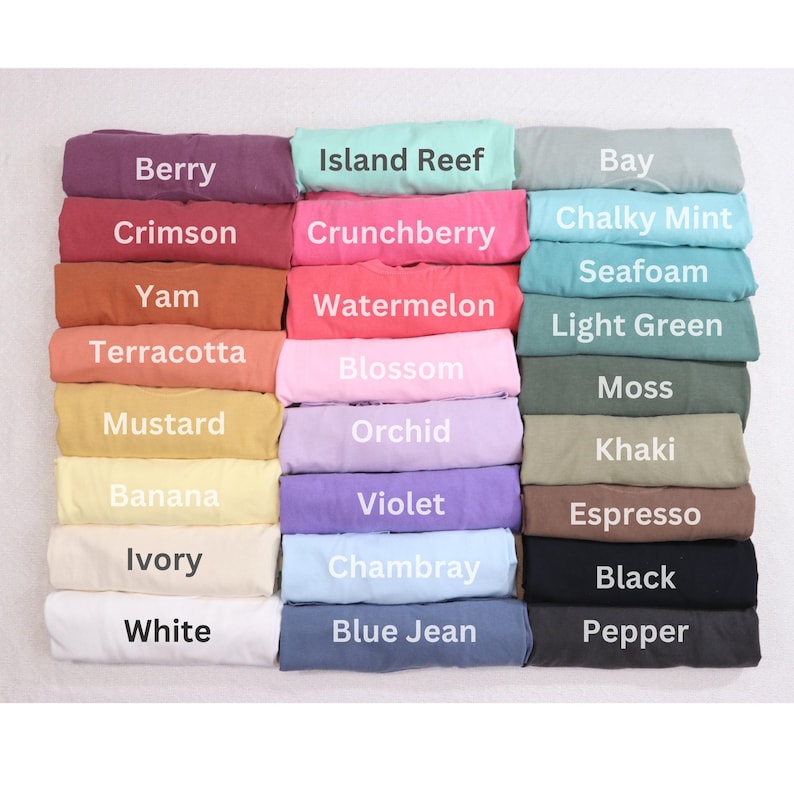 May include: A color chart of 24 fabric swatches, folded and stacked in three columns. The swatches are labeled with names like "Berry", "Island Reef", "Bay", "Crimson", "Crunchberry", "Chalky Mint", "Seafoam", "Yam", "Watermelon", "Terracotta", "Mustard", "Orchid", "Banana", "Ivory", "White", "Blossom", "Violet", "Chambray", "Light Green", "Moss", "Khaki", "Espresso", "Black", "Blue Jean", and "Pepper".