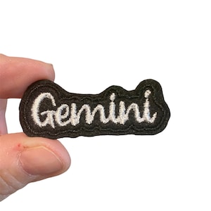 May include: White embroidered "Gemini" text on a black felt patch.
