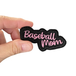 May include: Black felt patch with pink embroidered text that reads "Baseball Mom".