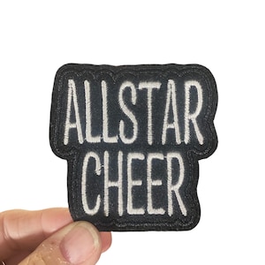 May include: Black iron-on patch with white embroidery that reads "ALLSTAR CHEER".