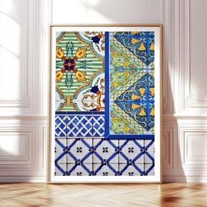May include: Framed art print featuring a collage of colorful, patterned tiles. The design includes green, yellow, blue, and white floral and geometric motifs. The artwork is displayed in a gold frame, leaning against a white wall and wooden floor.