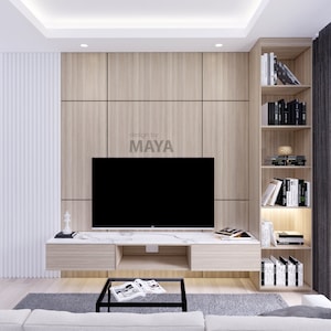 May include: A modern living room with a flat screen TV mounted on a wood panel wall. The TV is on a white marble entertainment centre with two drawers. A grey rug is on the floor in front of a black coffee table. A bookshelf with white books is on the right side of the wall. The text "design by MAYA" is on the wall.