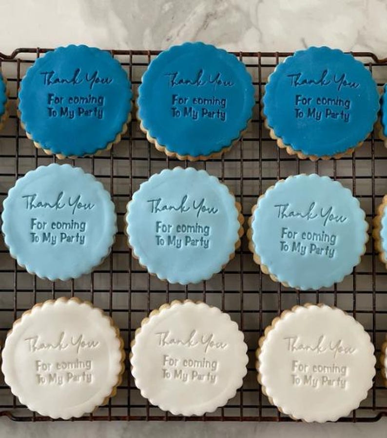 May include: Nine round cookies decorated with blue and white icing. Each cookie has the text "Thank You For coming To My Party" written on it.