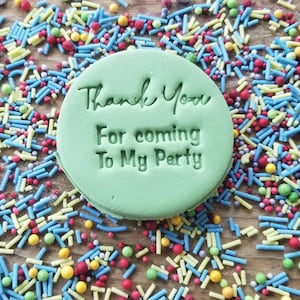 May include: A green round cookie with the text "Thank You For coming To My Party" in white lettering. The cookie is surrounded by colorful sprinkles.