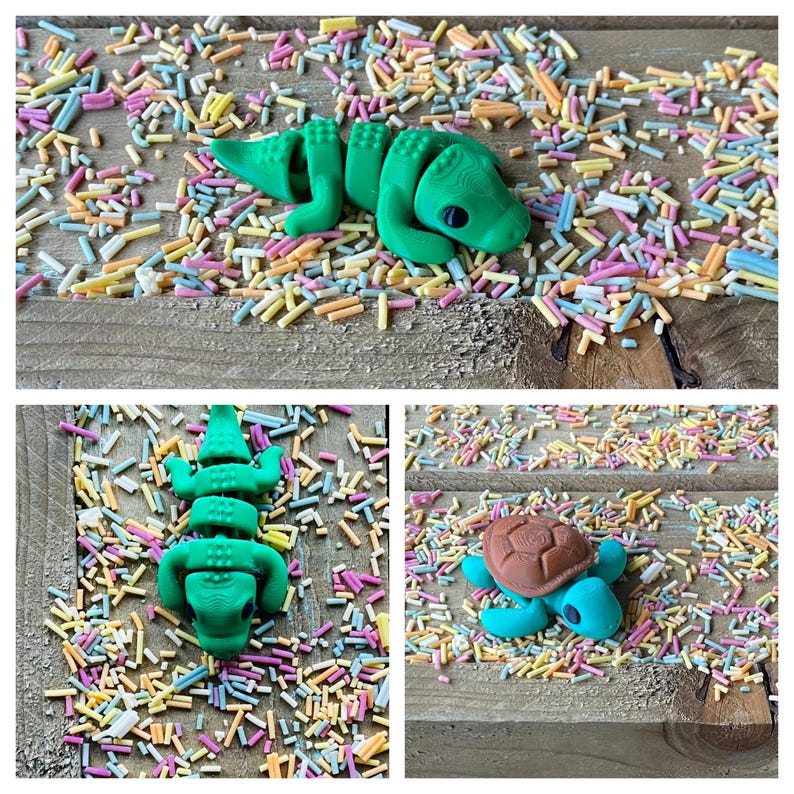 May include: Two green alligator figurines and a brown turtle figurine on a wooden surface covered in colorful sprinkles.