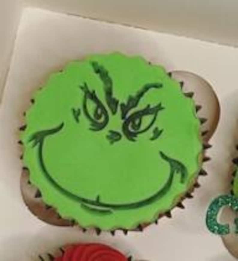 May include: Green cupcake with green frosting and a Grinch face design.