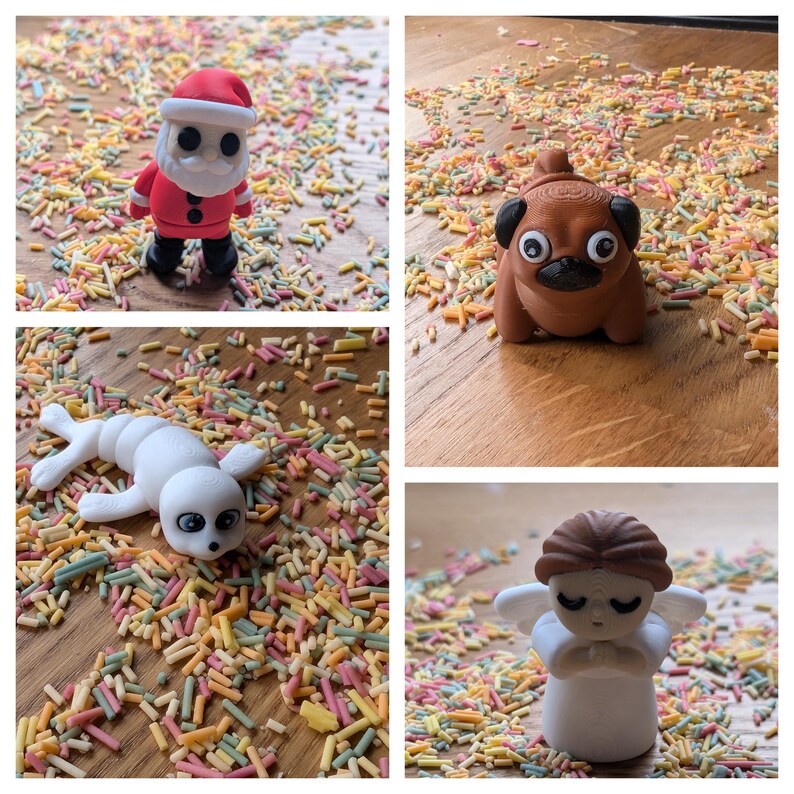 May include: Four small figurines on a surface covered in colorful sprinkles. The figurines are a Santa Claus, a pug, a seal, and an angel. The figurines are all made of a white material and have painted details.