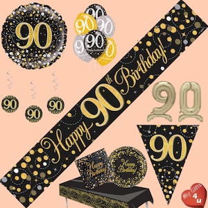 May include: Black and gold 90th birthday party decorations. The set includes a banner that says "Happy 90th Birthday!" with gold confetti, a large black and gold foil balloon with the number 90, three smaller black and gold balloons with the number 90, two gold foil number 90 balloons, a black and gold table cover, two black and gold plates with the text "Happy Birthday!" and a black and gold pennant with the number 90.