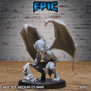 May include: A gray, detailed miniature figurine of a gargoyle with wings spread wide. The gargoyle is crouching and holding a pile of skulls in its hands. The base of the miniature is black and reads "BASE SIZE: MEDIUM (25.5MM)" and "#3915".