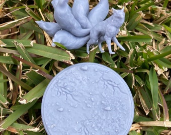 May include: A gray, detailed, 3D printed figurine of a nine-tailed fox with a textured base.