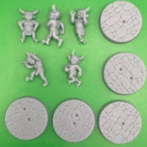May include: Set of six grey plastic miniature figurines of goblins, each with a different pose, and six grey plastic bases with a stone texture.