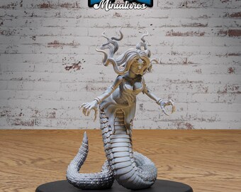 May include: Gray painted miniature figurine of a female serpent with a blindfold. The figure has a human upper body and a snake lower body. The base is black and the figure is 51mm tall.  #005