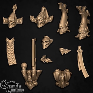 May include: A collection of bronze-colored miniature figurines, possibly for tabletop gaming or model building. The pieces include helmets, decorative elements, and other components, all with intricate, stylized designs. The logo "BattleYak Miniatures" is visible.