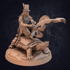 May include: A detailed sculpture depicts a Native American figure riding a giant turtle. The figure wears a feathered hat and plays a flute, with a stylized bird in flight nearby. The sculpture is rendered in a neutral, earthy tone.
