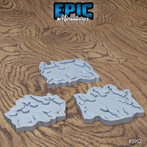 Könnte beinhalten: Drei graue Miniatur-Geländestücke mit einer rissigen, strukturierten Oberfläche. Die Teile sind unregelmäßig geformt und scheinen aus Kunststoff zu sein. Das Epic Miniatures-Logo ist oben sichtbar. Der Produktcode #5952 befindet sich unten.
