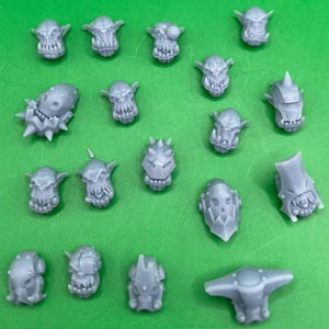 May include: A collection of 17 unpainted miniature plastic figures of orcs and goblins. The figures are in various poses and have different weapons and armour.