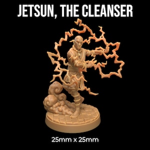 May include: A miniature figurine of a bald, light-skinned man wearing a brown robe and holding a glowing orb of energy. The figurine is standing on a circular base with a textured surface. The text "JETSUN, THE CLEANSER" is displayed above the figurine. The base of the figurine is 25mm x 25mm.
