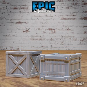 May include: Two wooden crates, one larger than the other, with a light grey finish and a simple design. The crates have a wood grain texture and are made of sturdy wood. The crates are perfect for adding a rustic touch to any room or for use in a tabletop game.