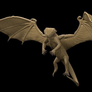 May include: A tan dragon figurine with outstretched wings, set against a black backdrop. The dragon has a lizard-like body, detailed wings, and is in a flying pose. The figurine is a fantasy-themed item.