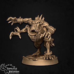 May include: A bronze-coloured miniature monster figurine with sharp teeth, claws, and a long tongue. The creature has multiple rings on its arms and legs, and is standing on a circular base. The BattleYak Miniatures logo is visible.